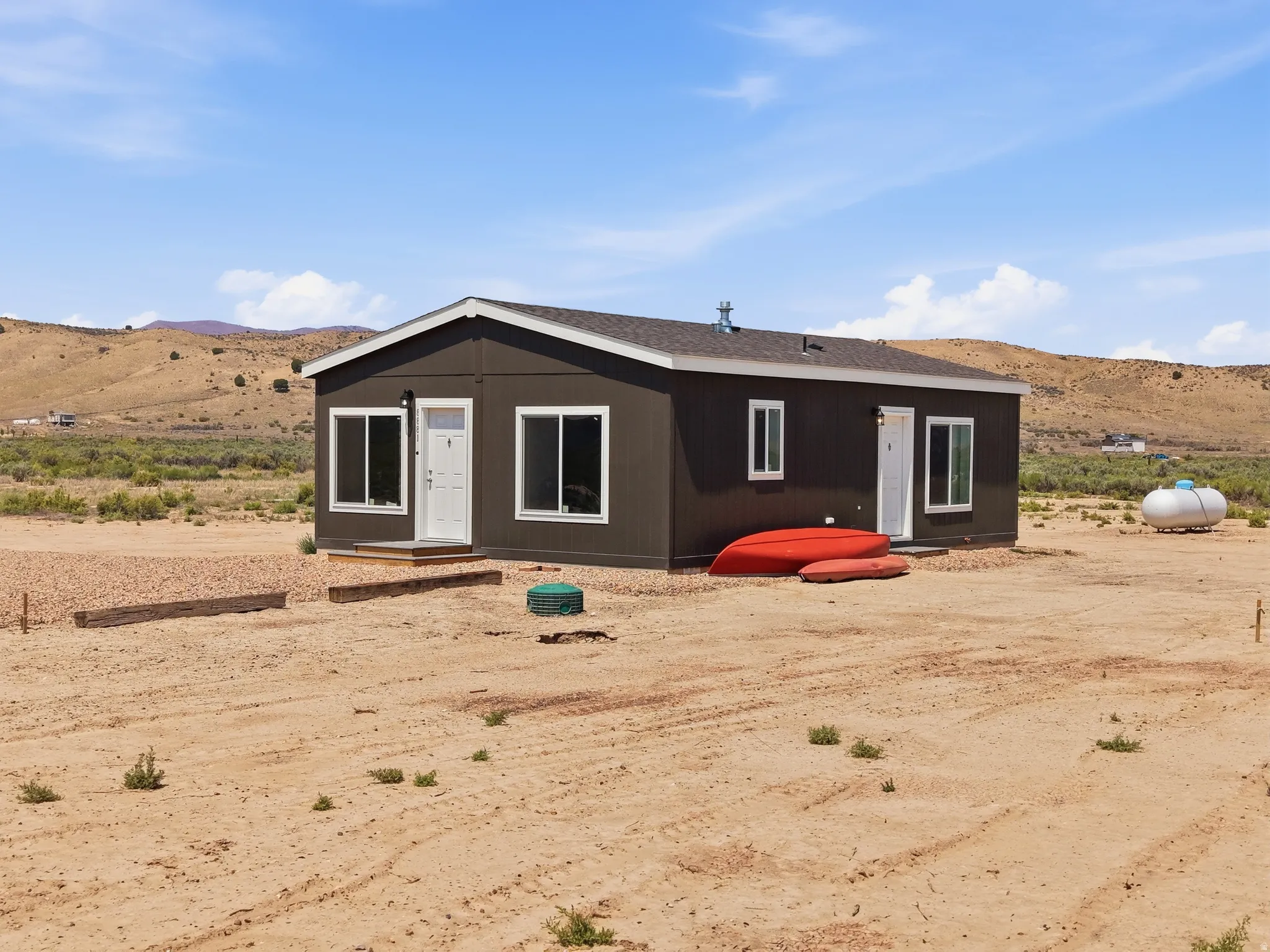 Manufactured home with dark siding and white trim