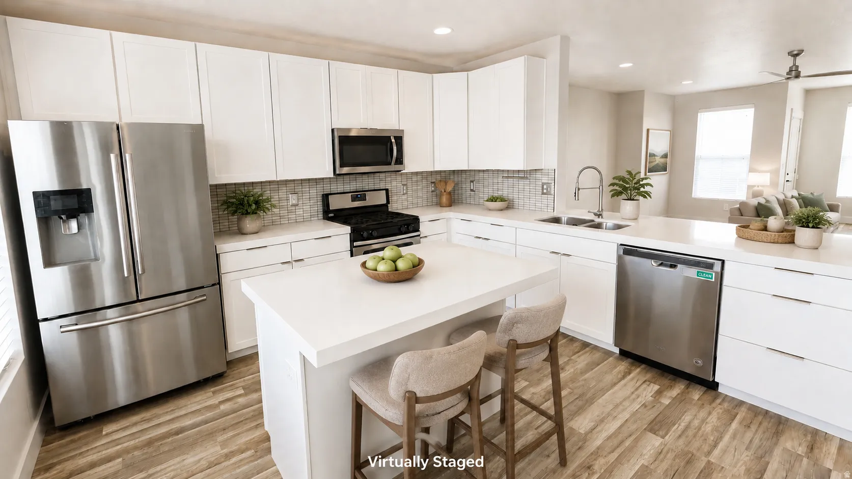 Kitchen featuring white cabinetry, stainless steel appliances, a center island with countertop seating, wood-finish flooring, and a tile backsplash