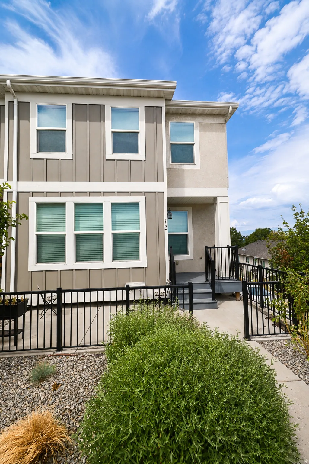 Contemporary exterior featuring vertical siding and stucco finishes