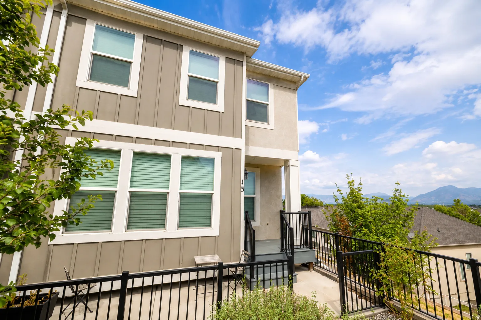 Two-story exterior with vertical siding and stucco finishes