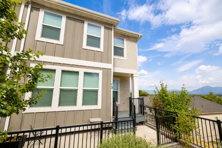 Two-story exterior with vertical siding and stucco finishes