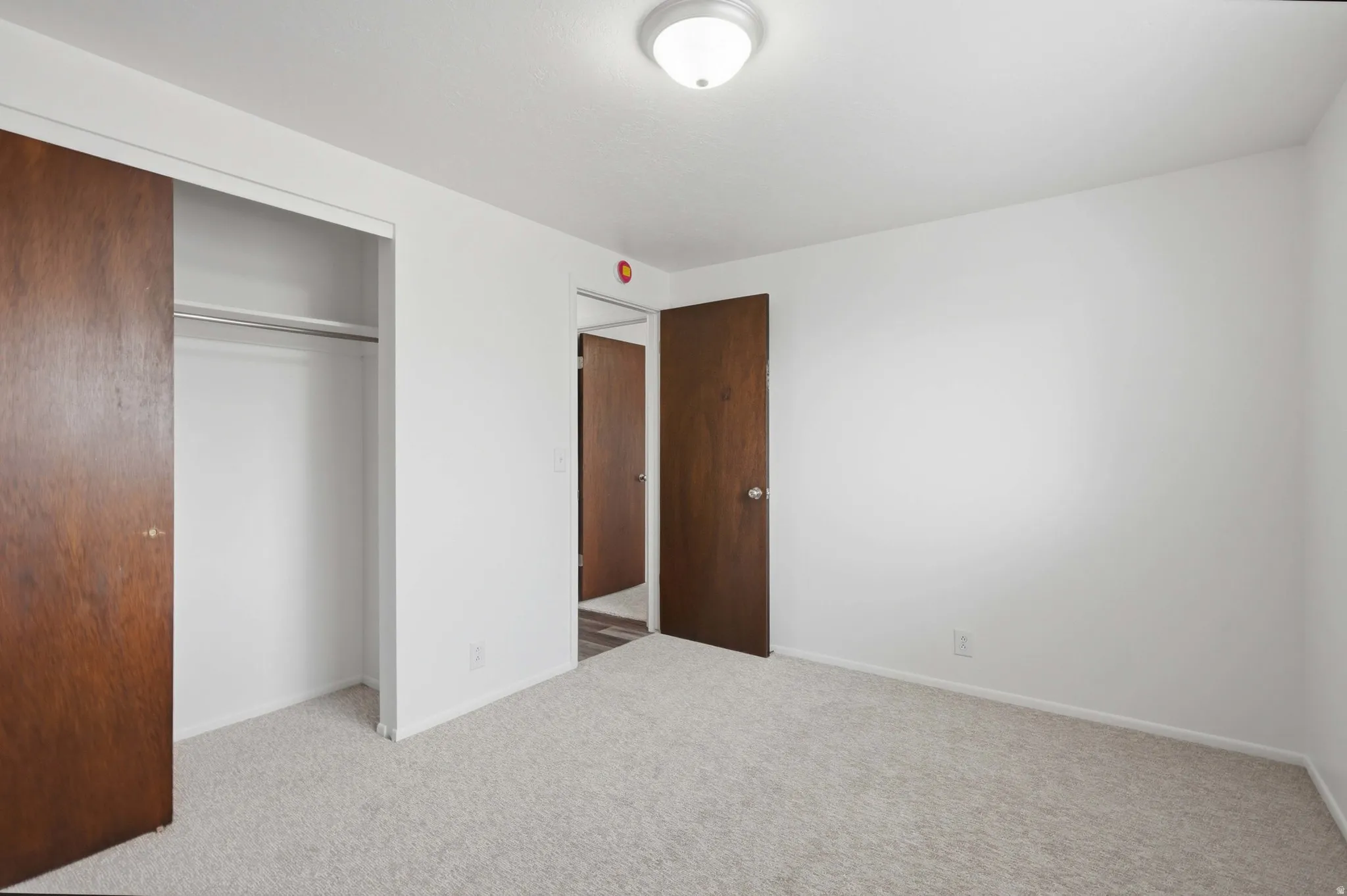 White walls with light-colored carpeting