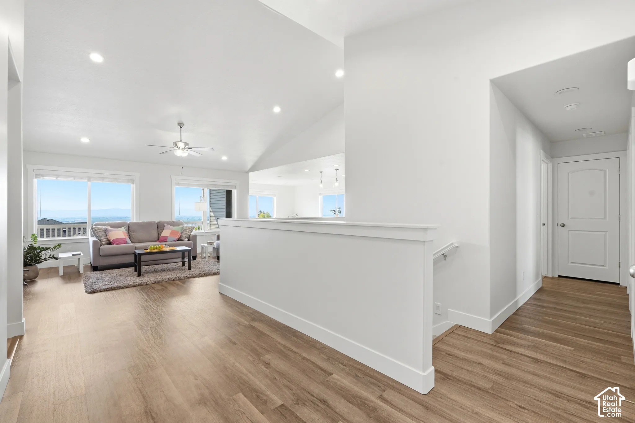 Vaulted ceilings, recessed lighting, and wood-finish flooring