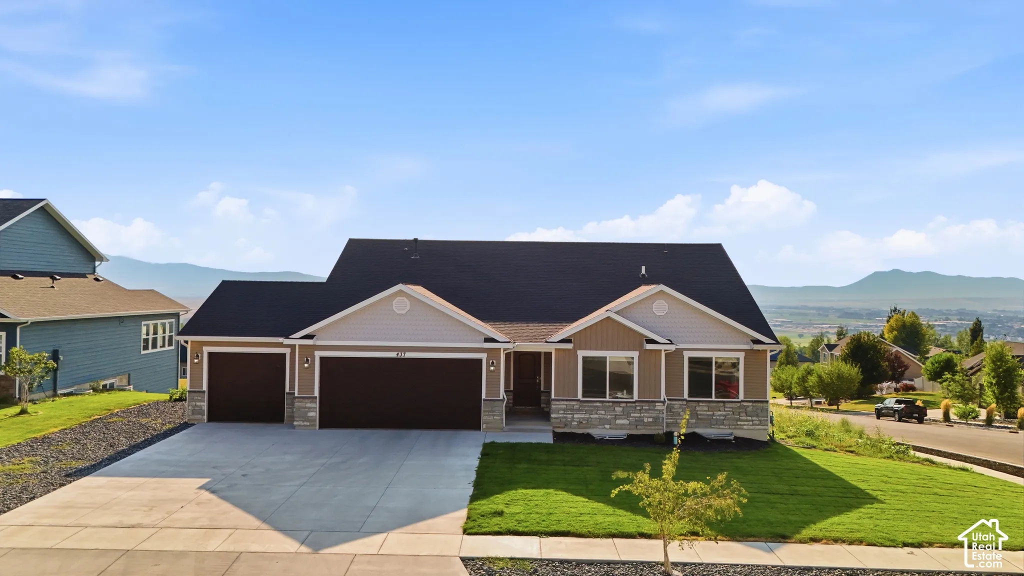 Exterior featuring a stone and siding facade, black shingle roof, attached two-car garage, and a concrete driveway