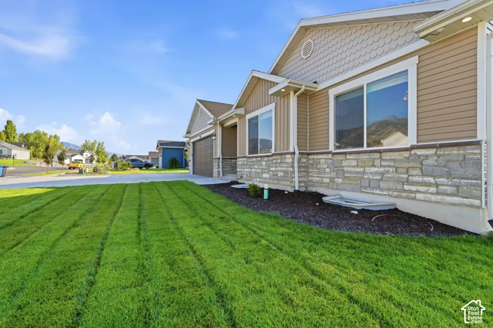 Exterior featuring horizontal siding, stone veneer accents, and shaker shingle gables
