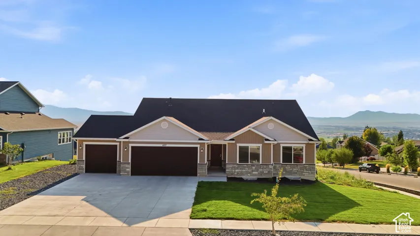 Exterior featuring a stone and siding facade, black shingle roof, attached two-car garage, and a concrete driveway