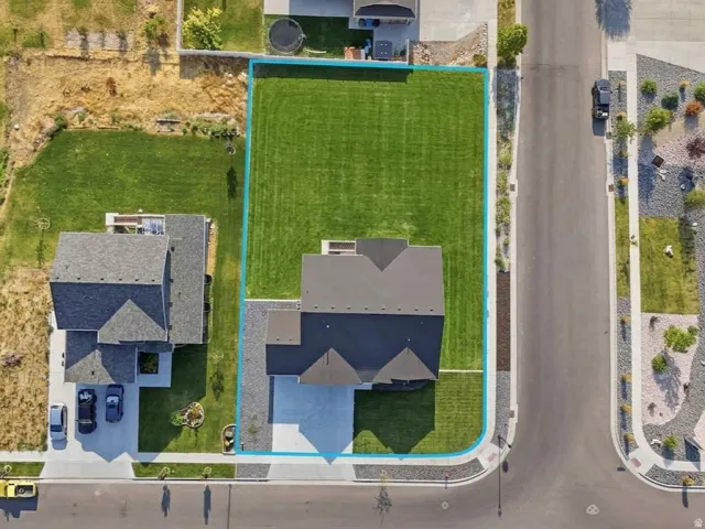 AI GENERATED Manicured lawn, paved driveway, asphalt shingle roof, concrete sidewalks, and an established street