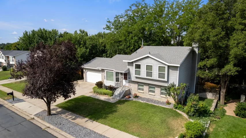Two-story siding exterior with an attached garage and a concrete driveway