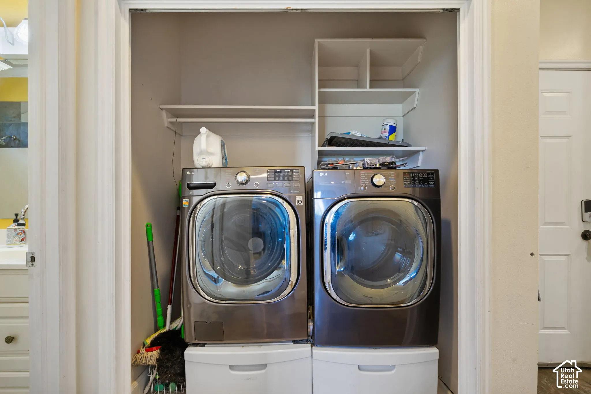 Laundry closet featuring built-in shelving