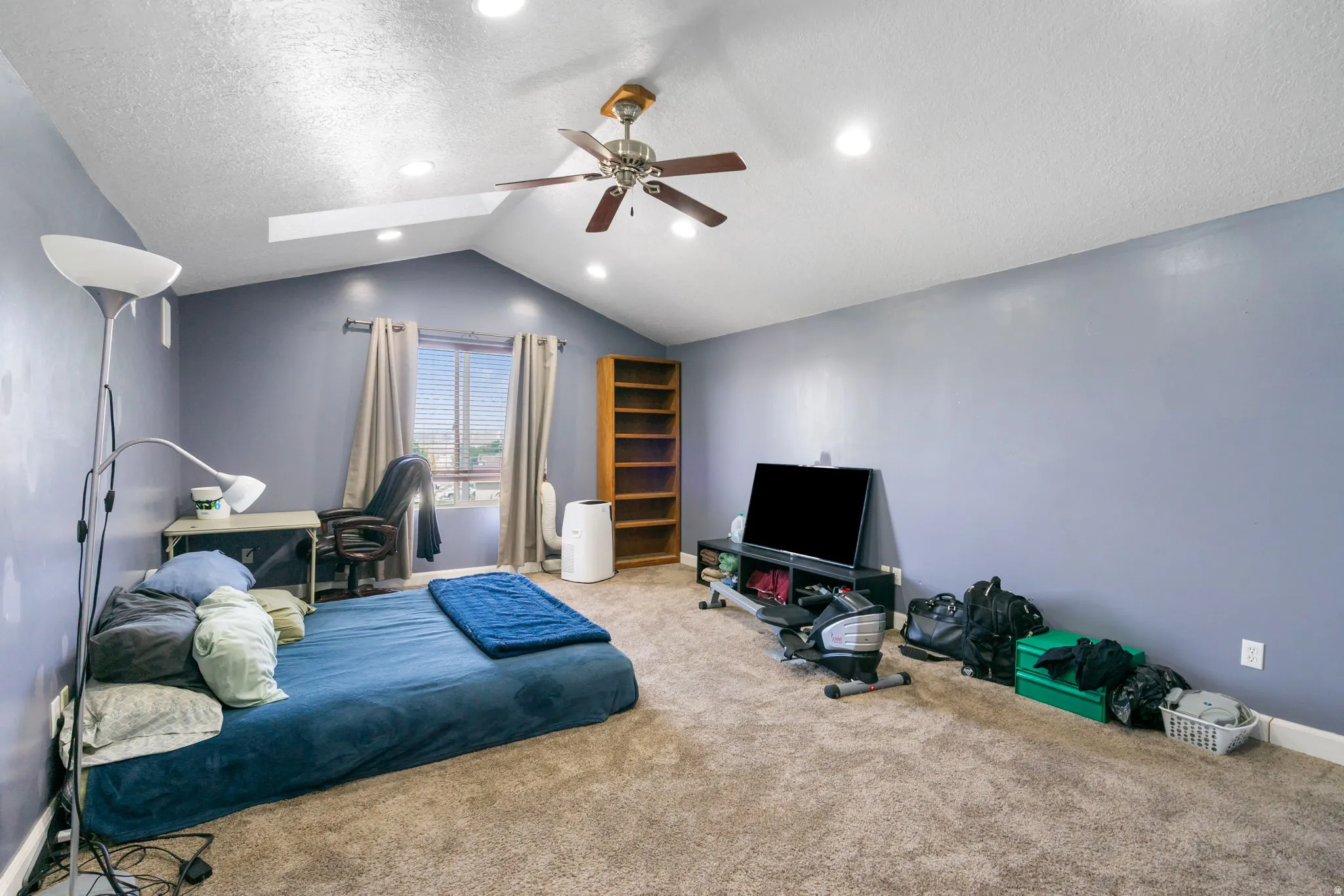 Vaulted ceiling with recessed lighting and a ceiling fan, carpeted flooring, and a window with blinds