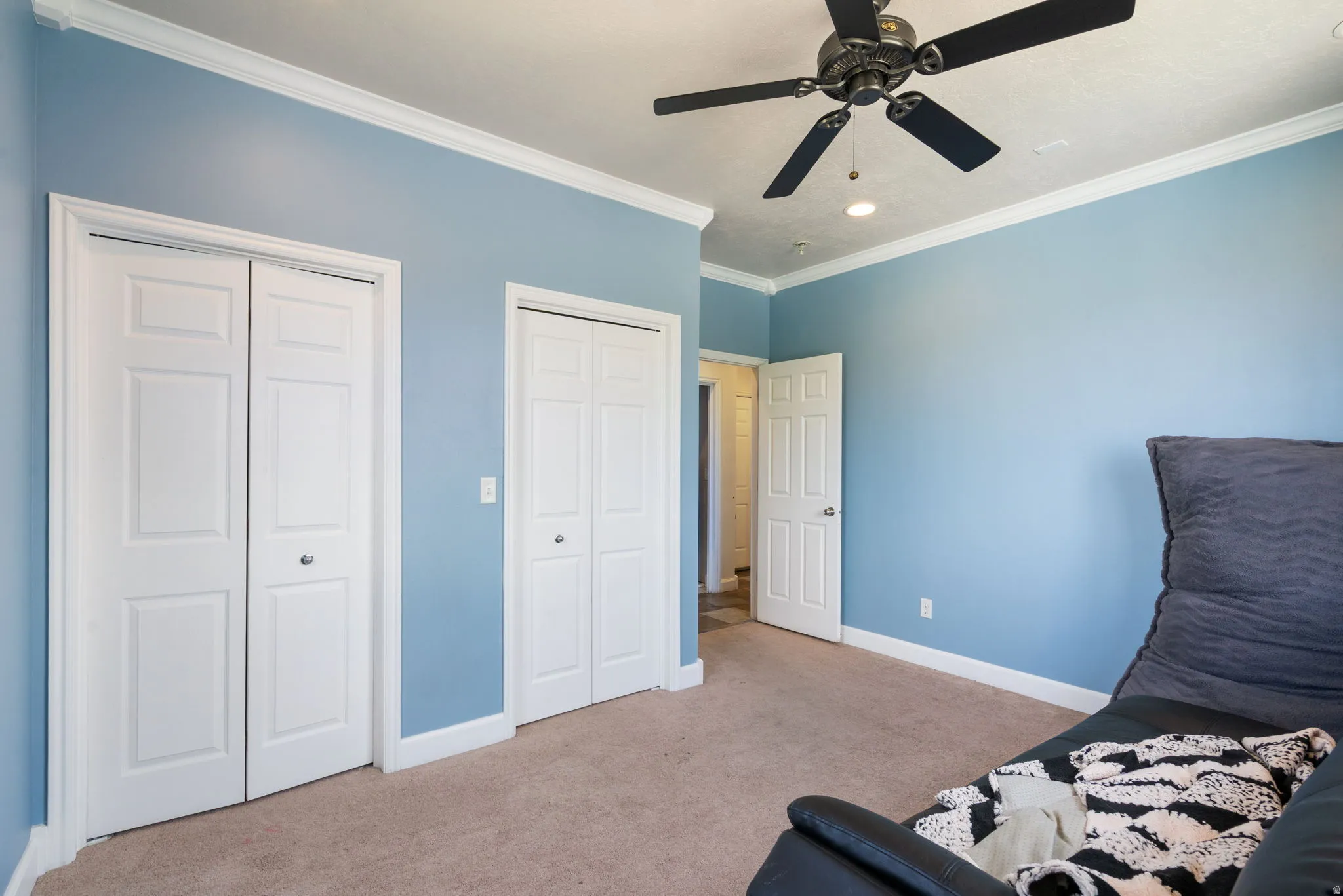 Recessed lighting, crown molding, ceiling fan, bi-fold closet doors, and carpet flooring