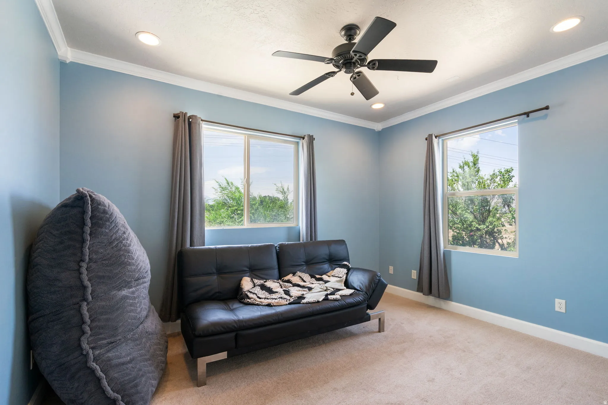 Recessed lighting, crown molding, and a ceiling fan with integrated light