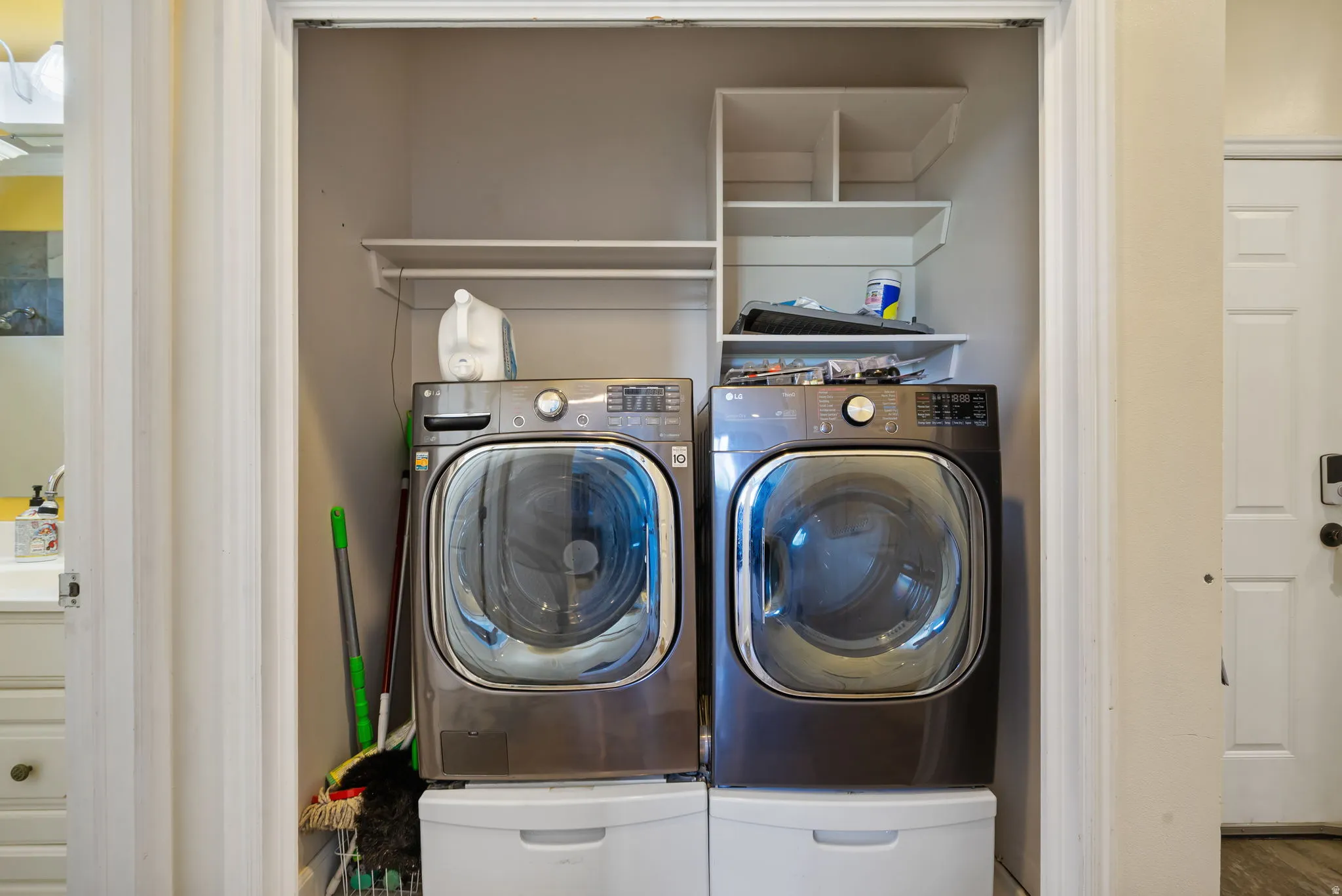 Laundry closet featuring built-in shelving