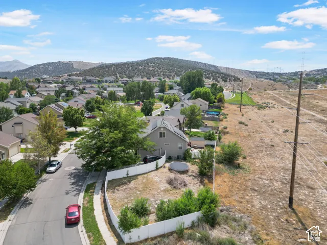 Residential setting with established homes, paved streets, and mountainous terrain