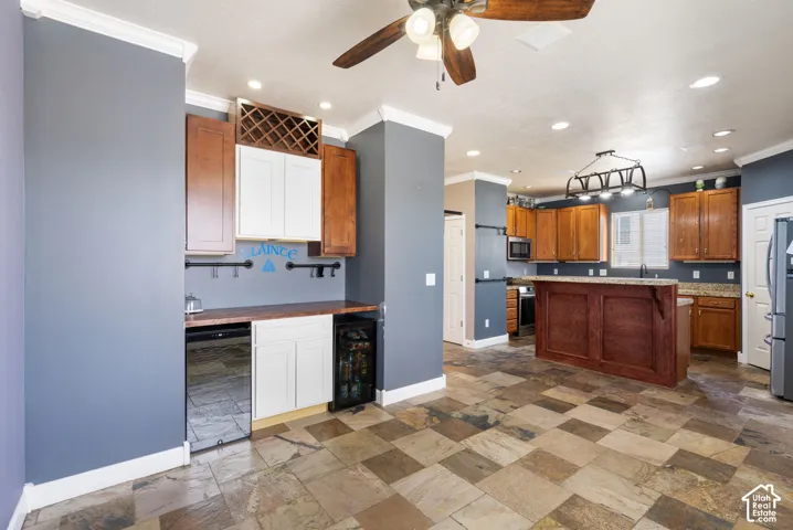 Checkerboard tile flooring, built-in beverage refrigerator, wood cabinetry, built-in wine rack, and recessed lighting