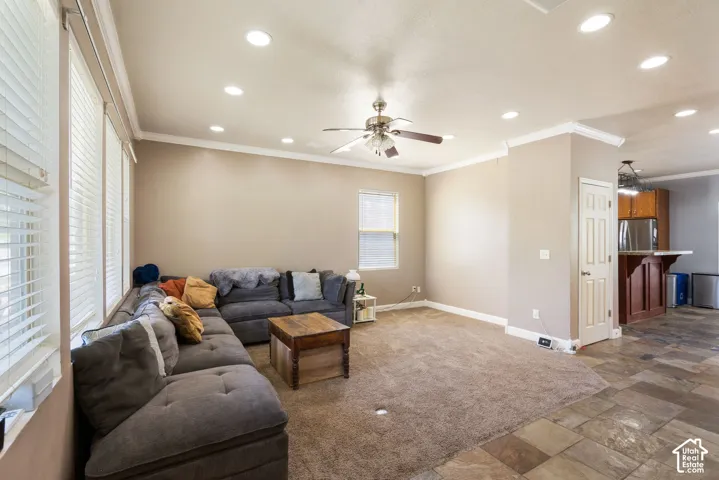 Recessed lighting, ceiling fan, crown molding, multiple windows with blinds, and durable tile flooring