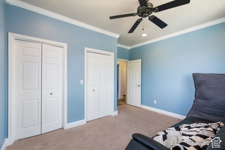 Recessed lighting, crown molding, ceiling fan, bi-fold closet doors, and carpet flooring