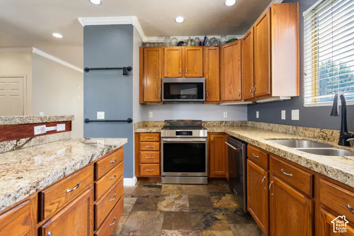 Wood-finish cabinetry complemented by light-toned, speckled countertops