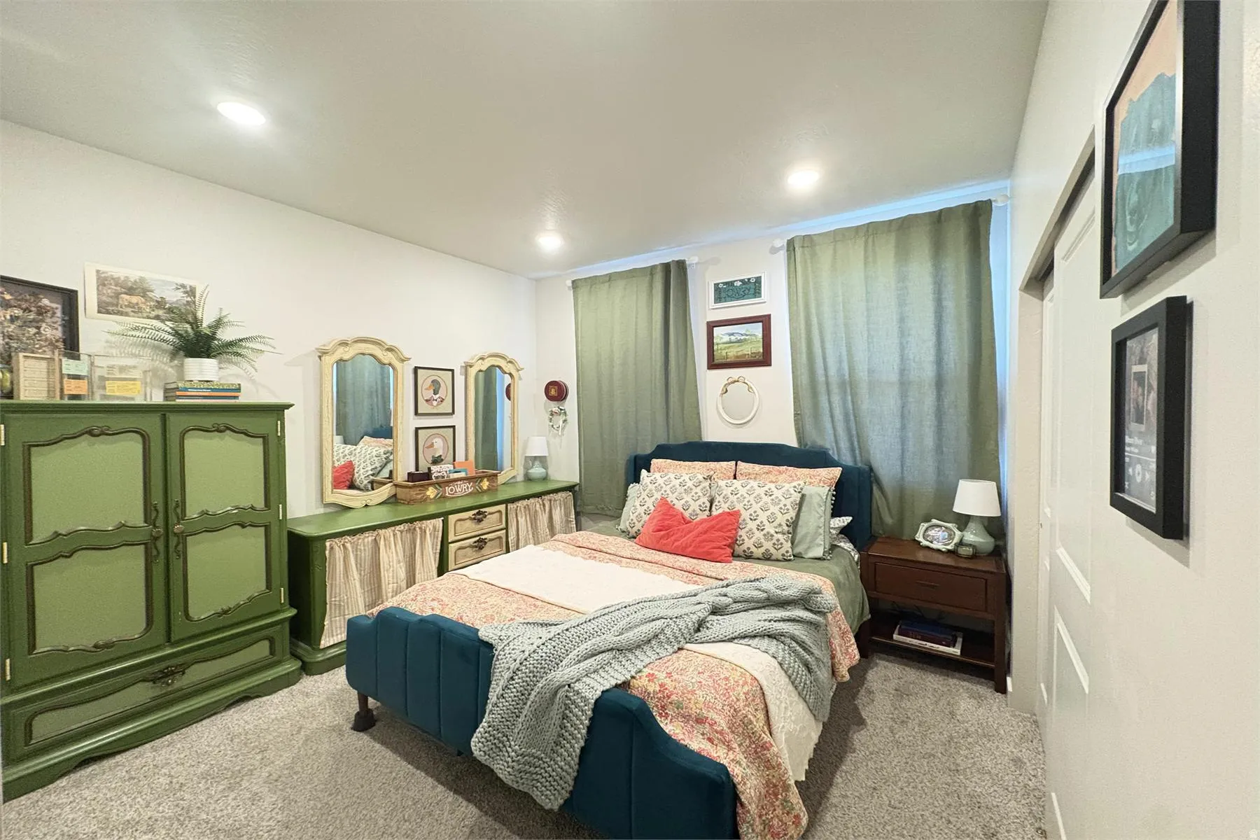 Recessed lighting, light-colored walls, and carpeted flooring