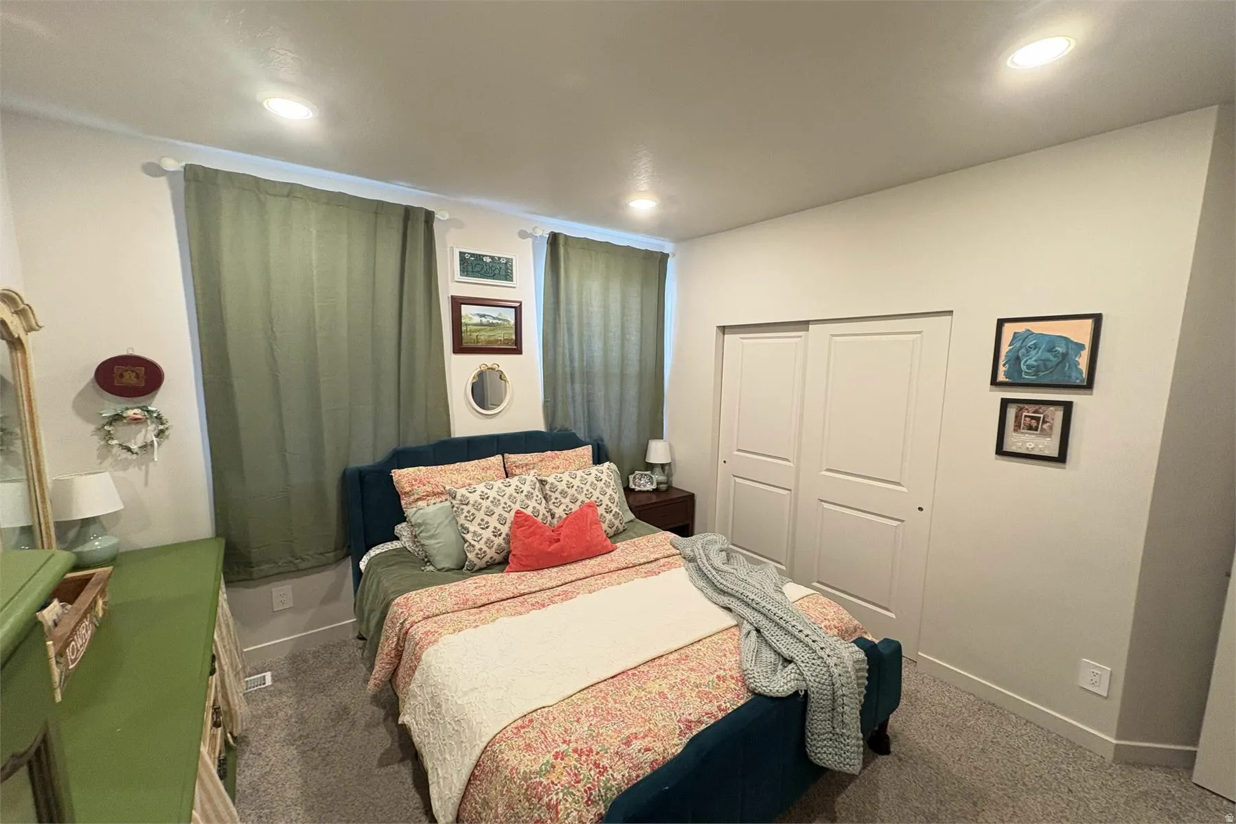Recessed lighting, light-colored walls, sliding closet doors, and carpeted flooring