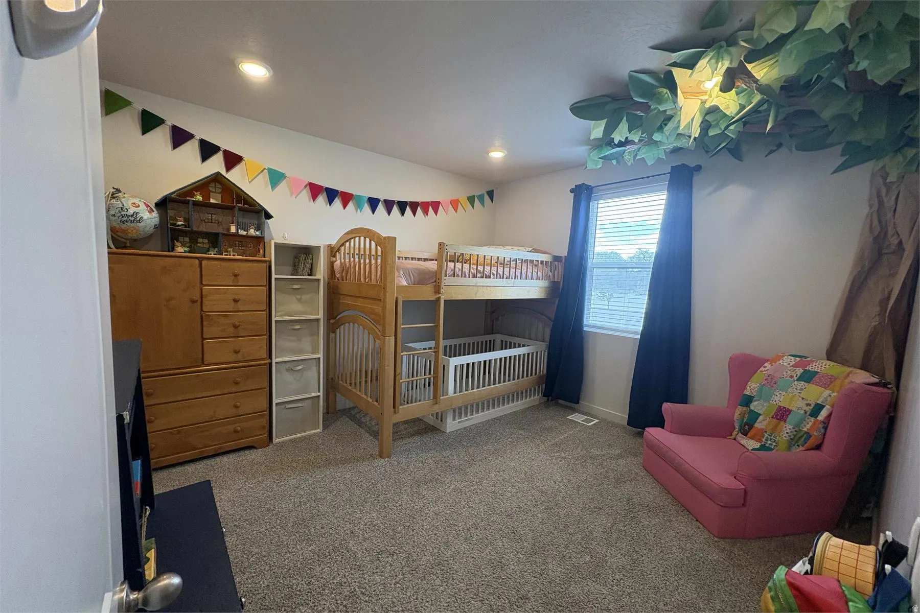 Carpeted room featuring a window with blinds and drapes, recessed lighting, and a sloped ceiling