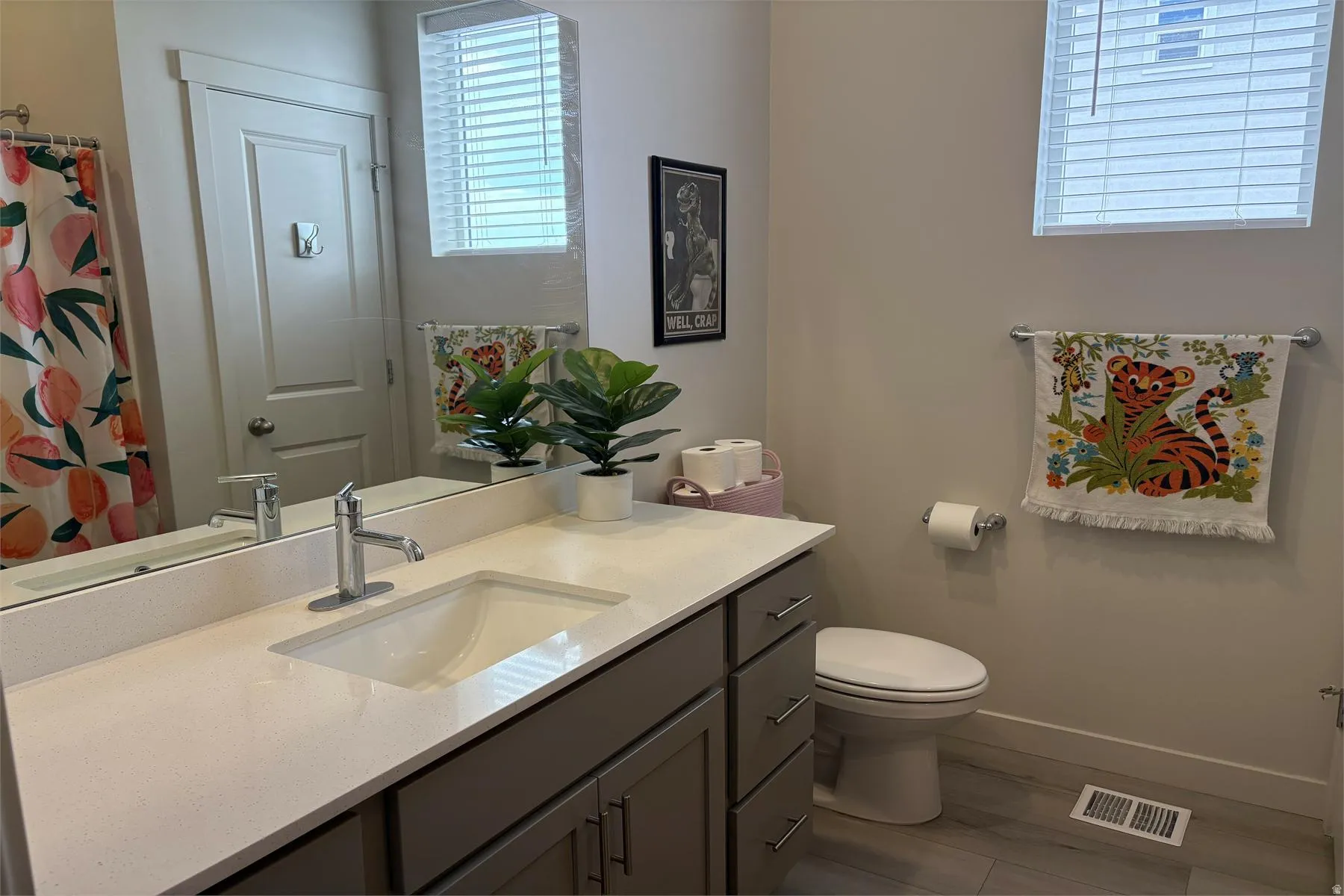 Vanity with an integrated rectangular sink, chrome faucet, and expansive mirror