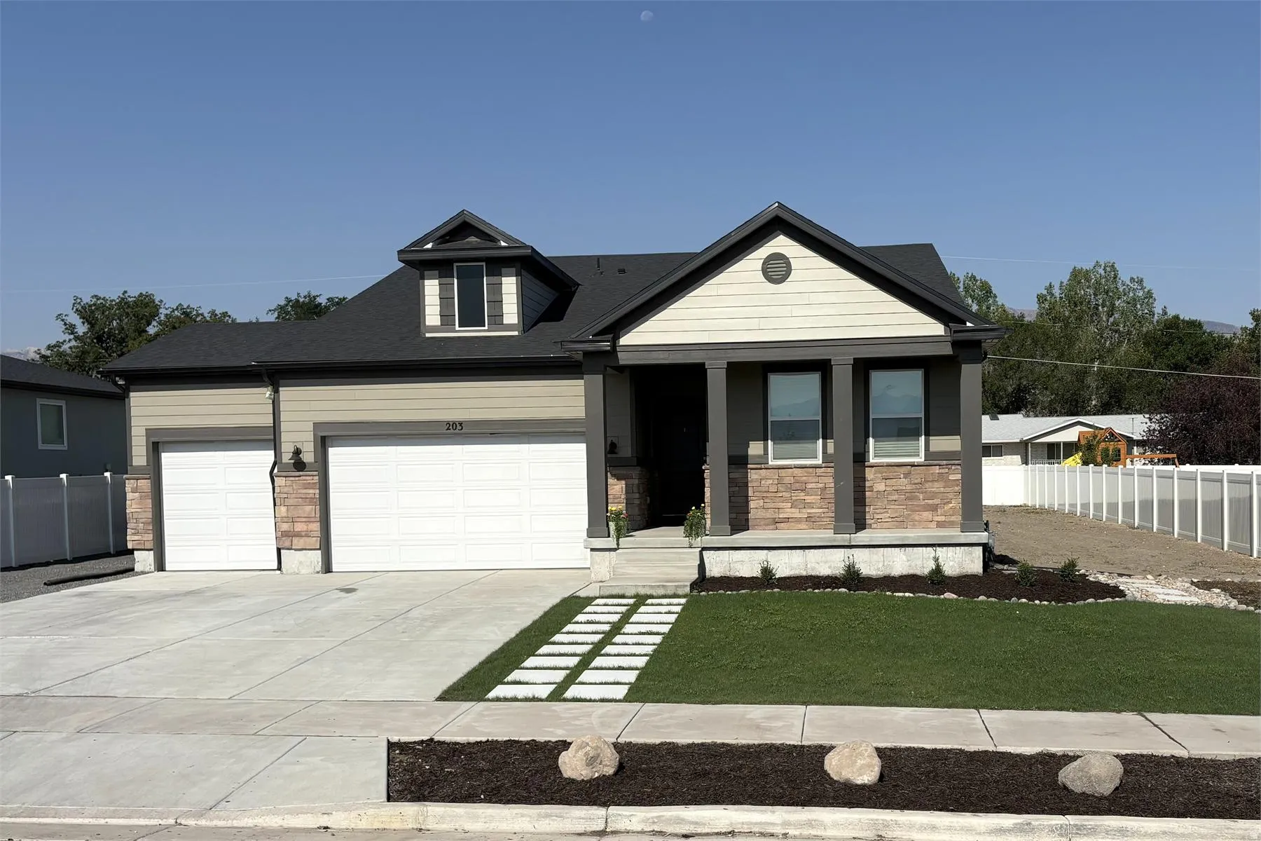 Contemporary exterior with stone accent siding and a dormer window