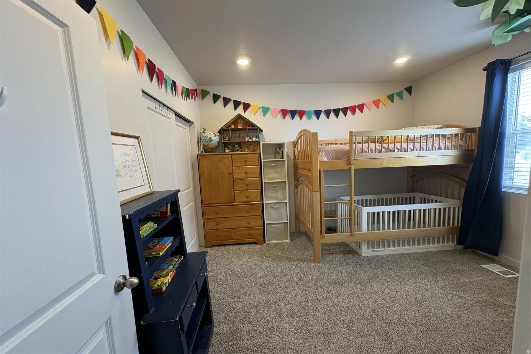 Recessed lighting, neutral wall tones, window with blinds, and carpeted flooring
