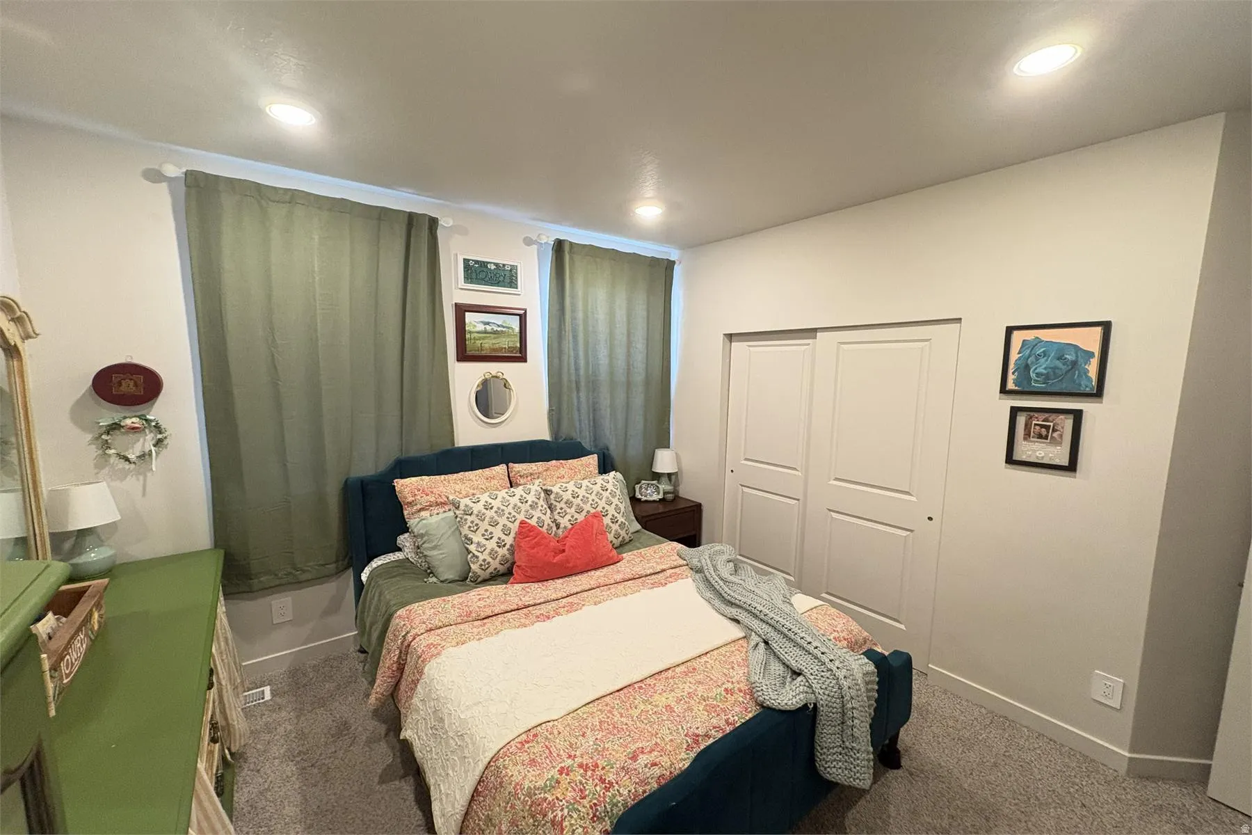 Recessed lighting, light-toned walls, and grey carpeting