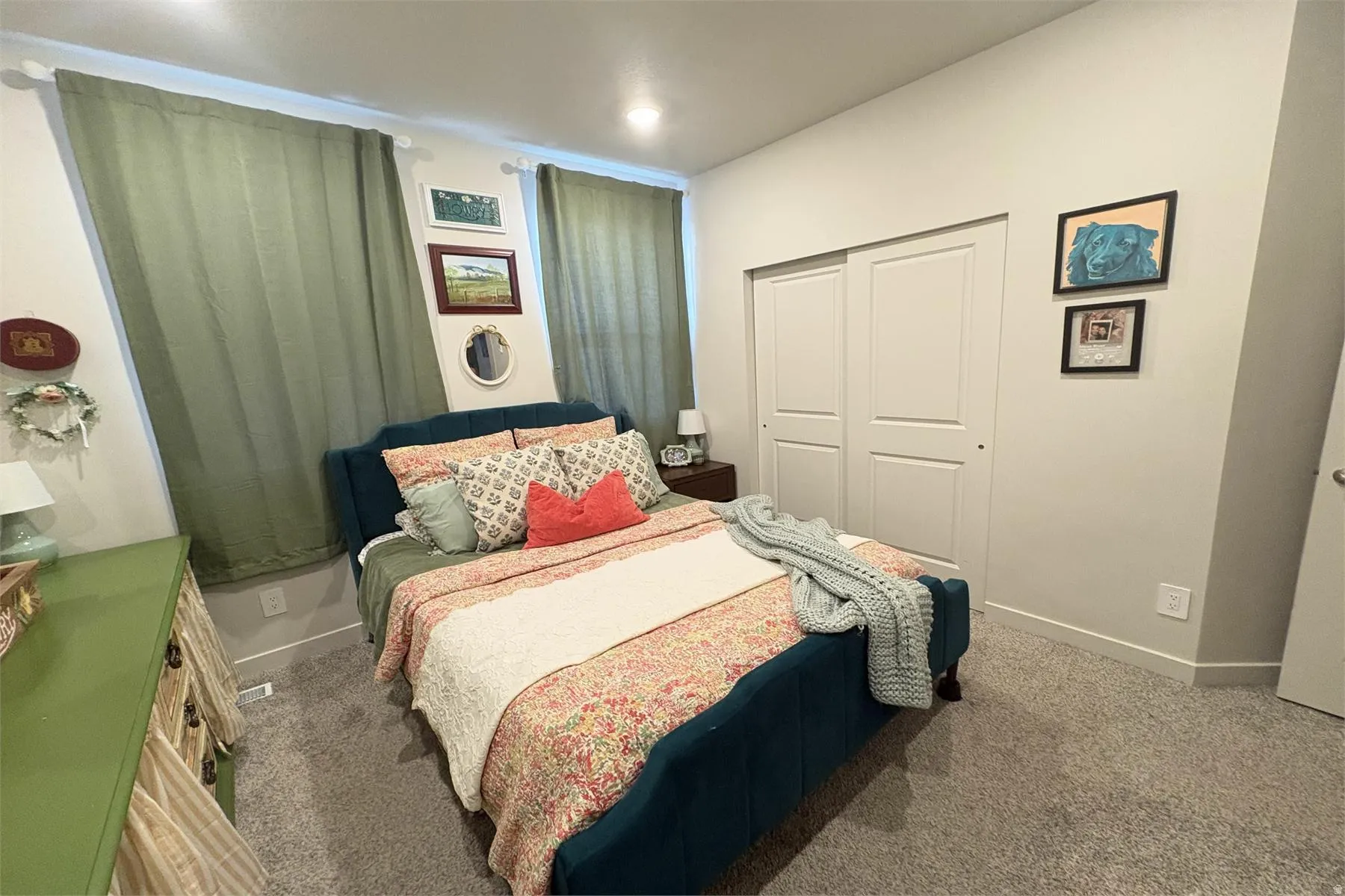Built-in closet with sliding doors, recessed ceiling lighting, and wall-to-wall carpeting