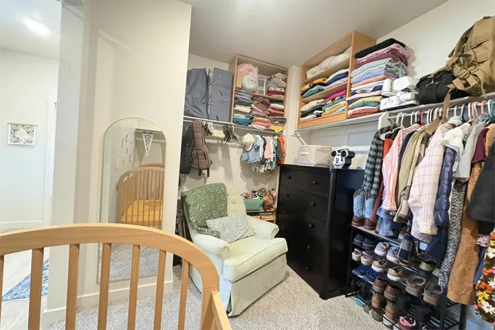 Custom shelving system with built-in clothing rods and wood-finish storage