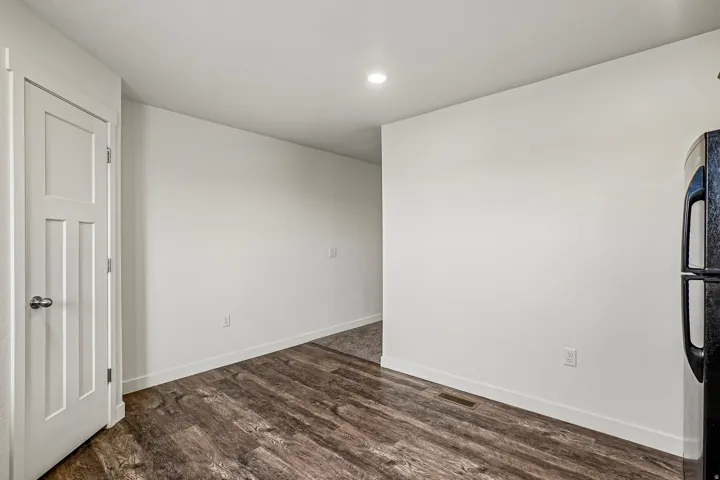 Wide plank wood-finish flooring complements crisp white walls