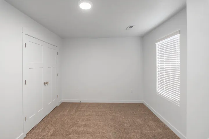 Neutral wall tones with plush carpeting and ample natural light