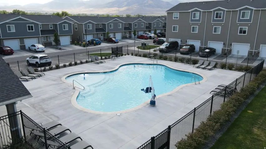Resort-style swimming pool with surrounding concrete patio