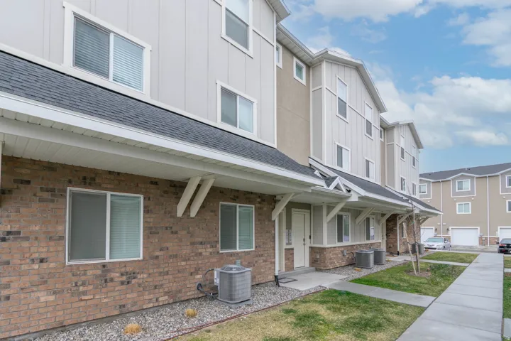 Multi-level residential building featuring brick and siding exterior construction