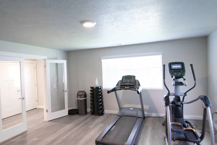 Versatile interior space featuring wood-finish flooring, neutral wall tones, and recessed lighting