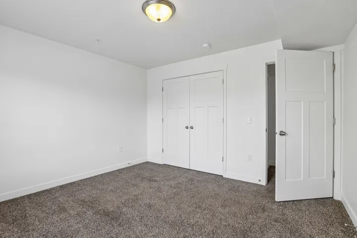 Neutral-toned carpeting defining a bright room