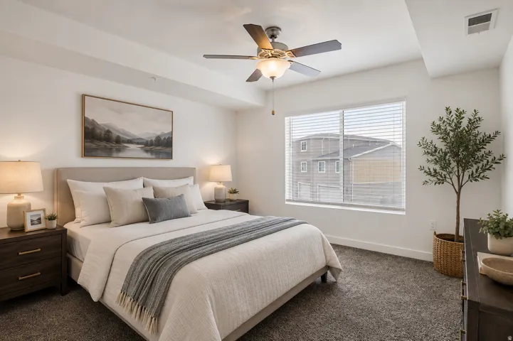 Carpeted bedroom with a ceiling fan, recessed lighting, and a large window with blinds