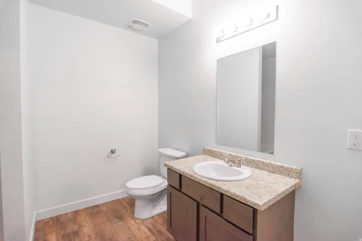Bathroom featuring a vanity with a light-toned countertop, an integrated sink, and a chrome faucet