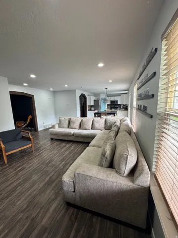 Recessed lighting, wood-finish flooring, and arched doorways