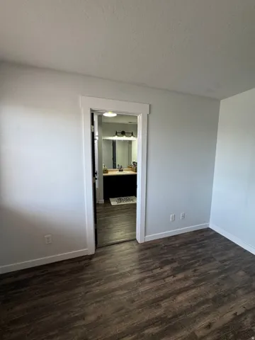 Wood-finish flooring throughout, white trim, and light wall finishes