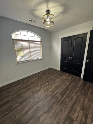 Wood-finish flooring with white baseboards