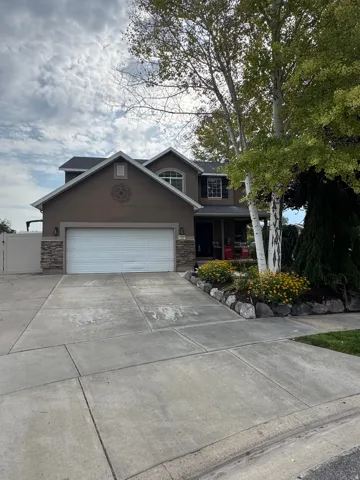 Two-story residence featuring a two-car garage with a concrete driveway