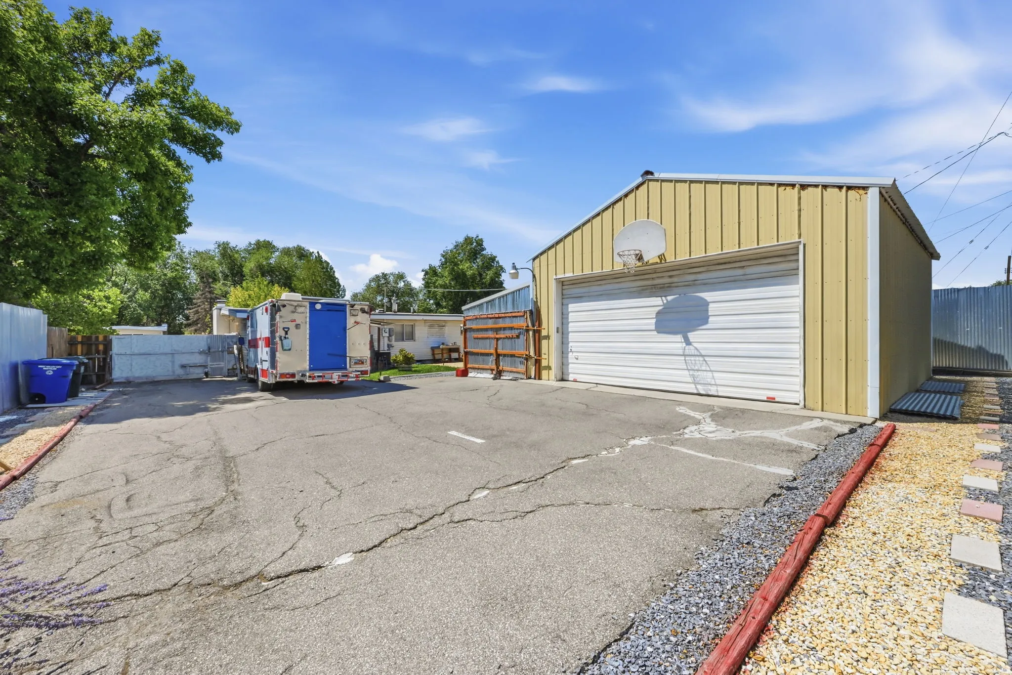 Detached metal-sided garage with a roll-up door