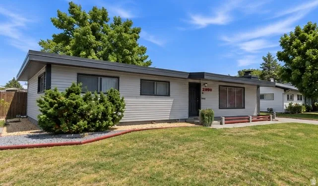 Light gray horizontal siding exterior with dark trim