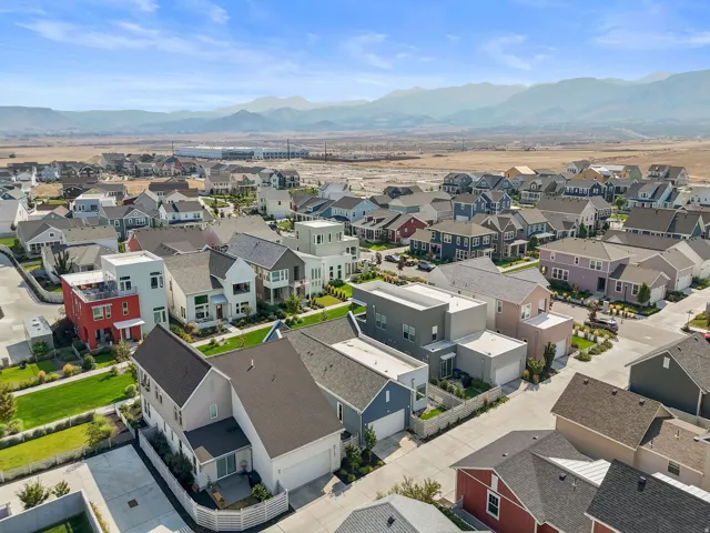 Residential development with diverse architectural styles, featuring pitched roofs, mountain scenery, and landscaped grounds