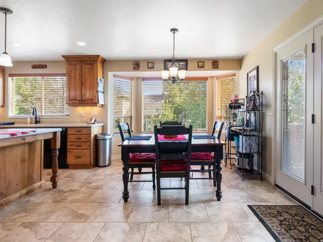 Breakfast nook in Kitchen featuring wood cabinetry, stone-finish countertops, and tile flooring