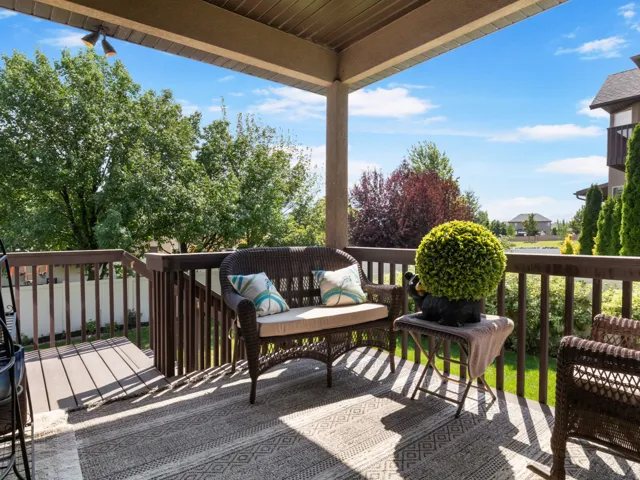 Expansive covered deck with composite decking, wood railing and lighting.