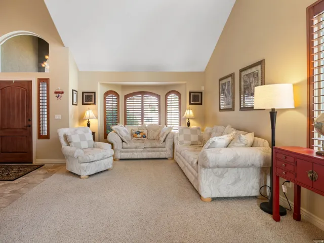 Formal Living Area. Vaulted ceilings complement the warm-toned walls
