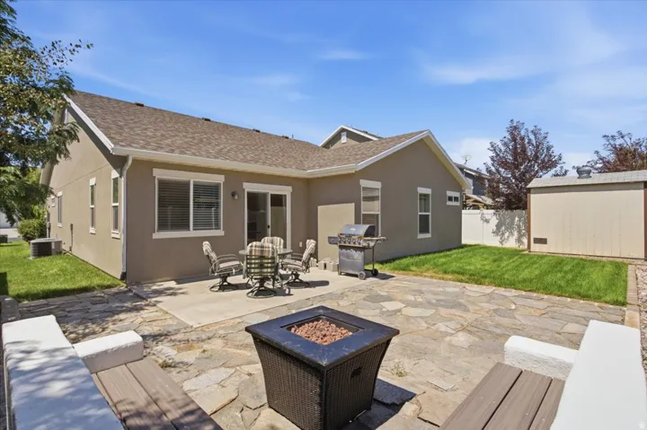 Spacious backyard featuring a flagstone patio, concrete patio, and built-in seating